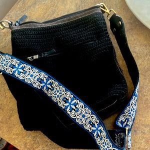 Black woven SAK Crossbody with aftermarket guitar strap.